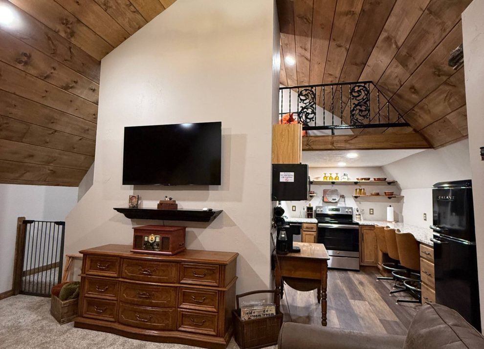 Living room, full kitchen and upstairs loft at Tate’s Hideaway near Mansfield, Missouri