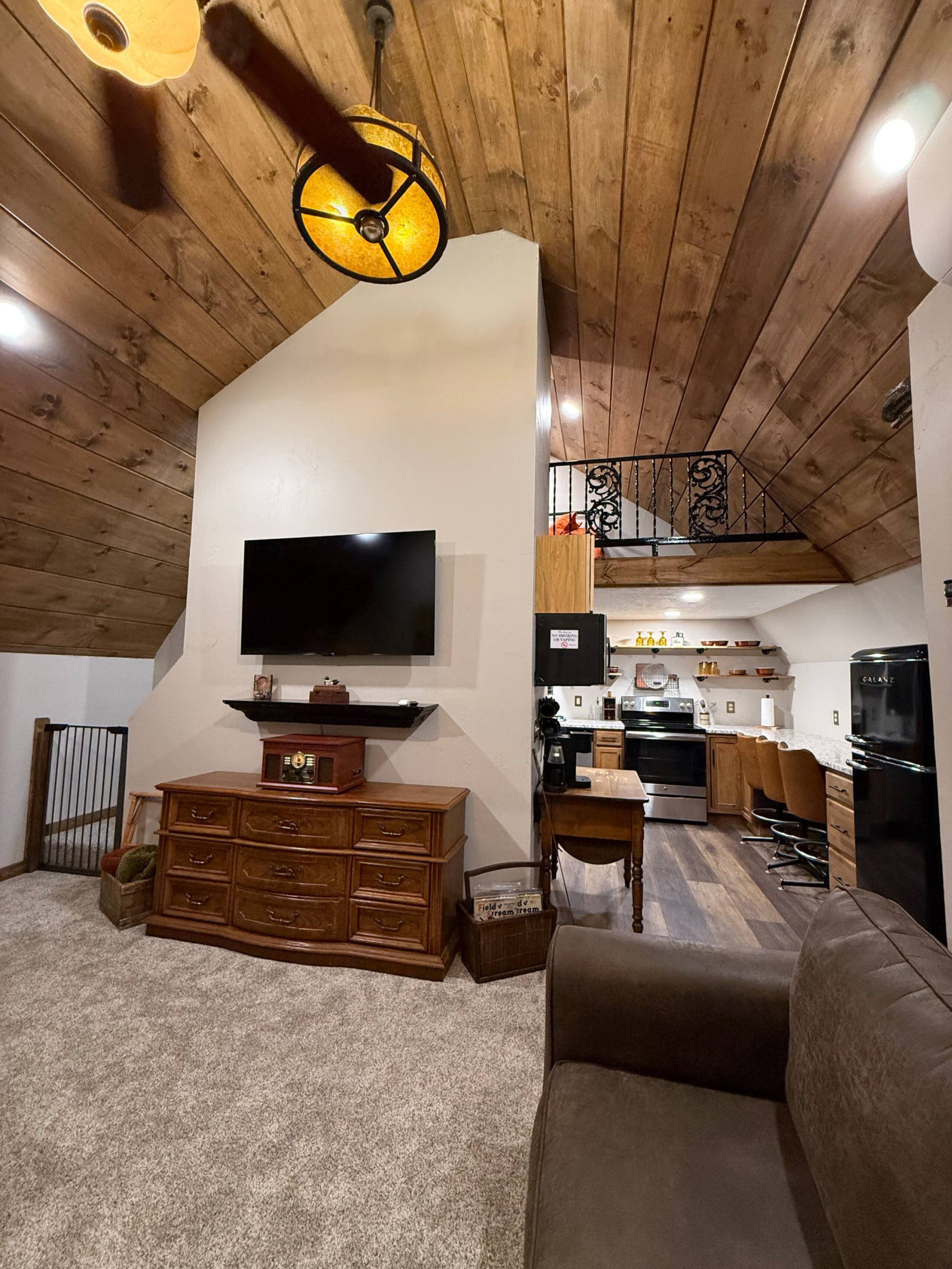 Living room, full kitchen and upstairs loft at Tate’s Hideaway near Mansfield, Missouri